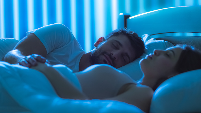 Couple asleep in bed