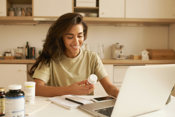 Young woman choosing a multivitamin supplement