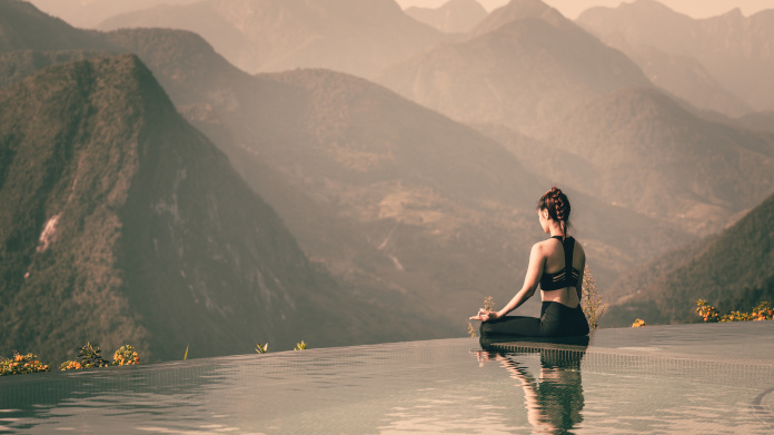 Woman meditating, to control her stress levels