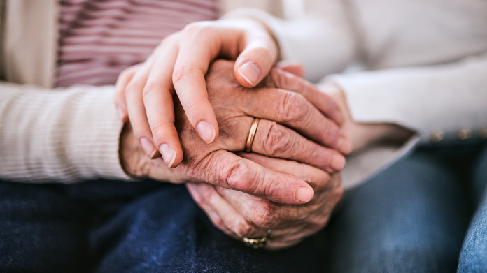 Older person’s hands showing wrinkles and aging spots