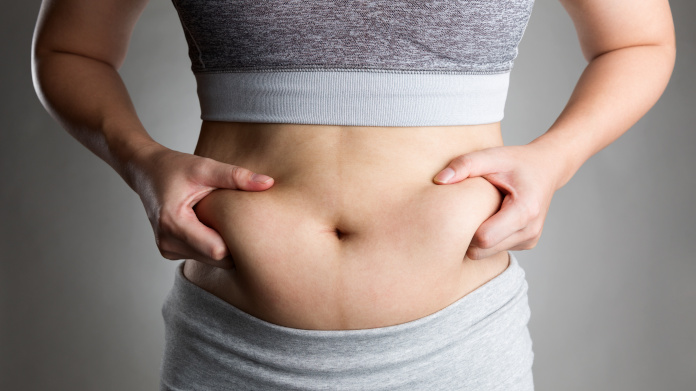 Woman jogging, showing her abdominal fat  